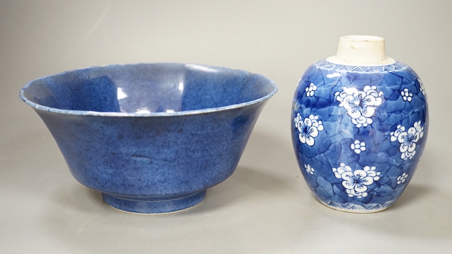 A Chinese powder blue bowl, early 18th century and a Chinese blue and white prunus jar - tallest 13cm